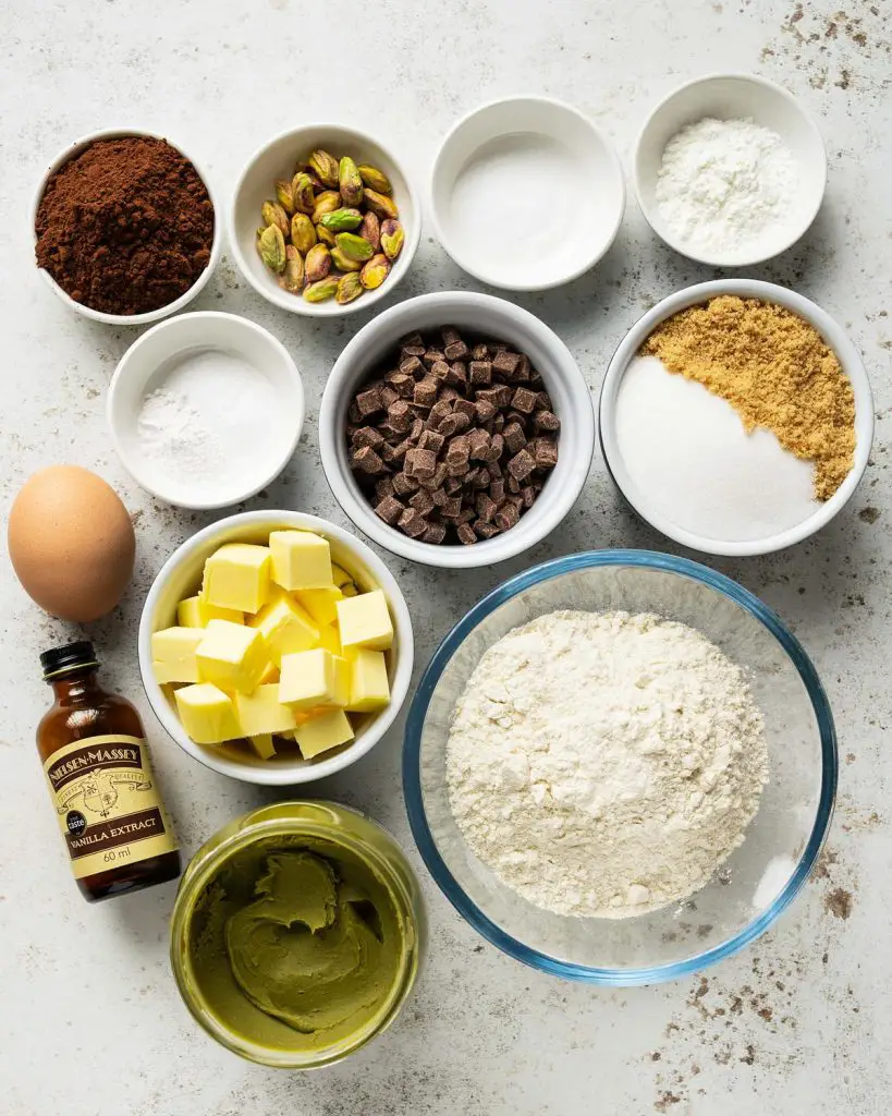 Ingredients required: unsalted butter, brown sugar, caster sugar, vanilla, plain (all purpose) flour, cocoa, cornflour (cornstarch), baking powder, bicarbonate of soda (baking soda), salt, chocolate chunks, pistachio cream, egg and pistachios. Recipe by movers and bakers