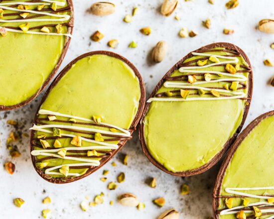 My chocolate pistachio easter egg cheesecake is utterly delightful! A milk chocolate easter egg is layered with pistachio kunafe and no bake pistachio cheesecake before being drizzled with milk and white chocolates and some chopped pistachios. Dubai chocolate heaven! Recipe by movers and bakers