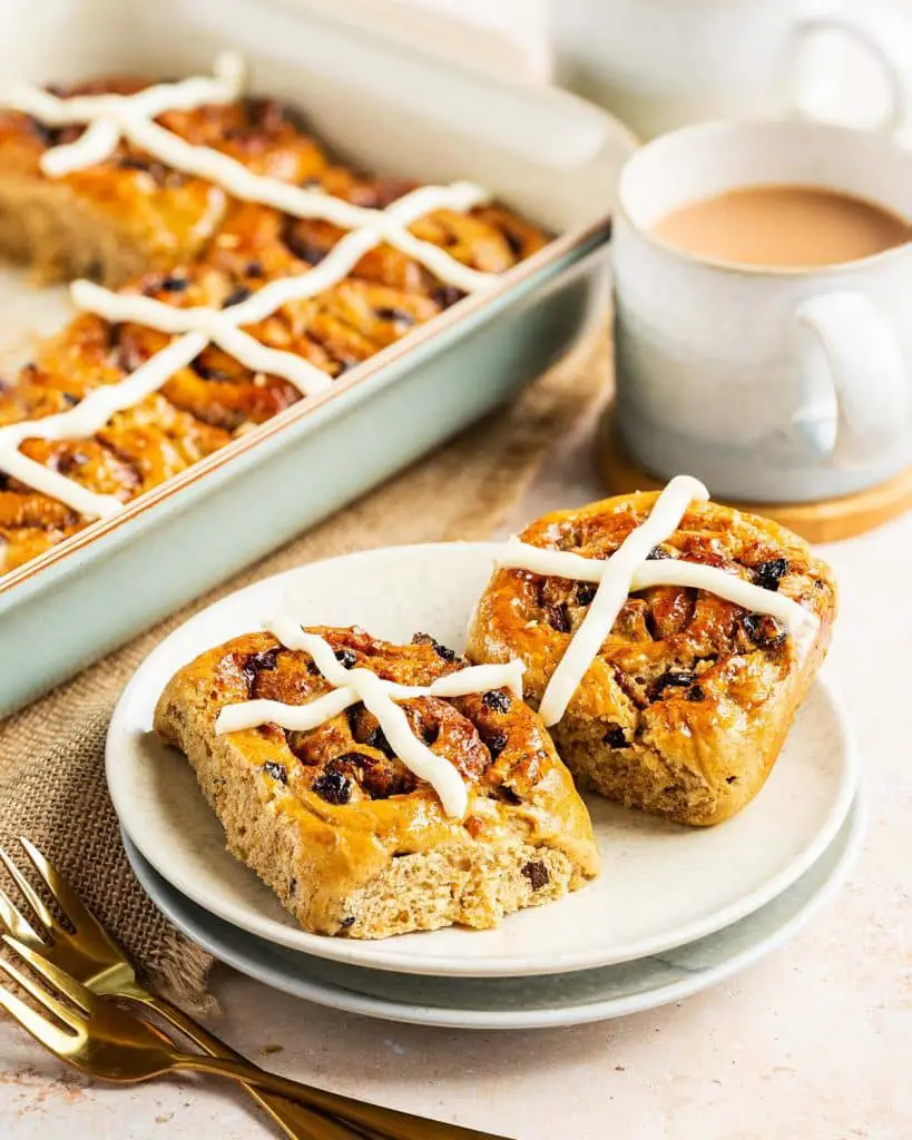 These delicious hot cross cinnamon buns have all the irresistible flavours of a hot cross bun, but in a cinnamon roll! Recipe by movers and bakers
