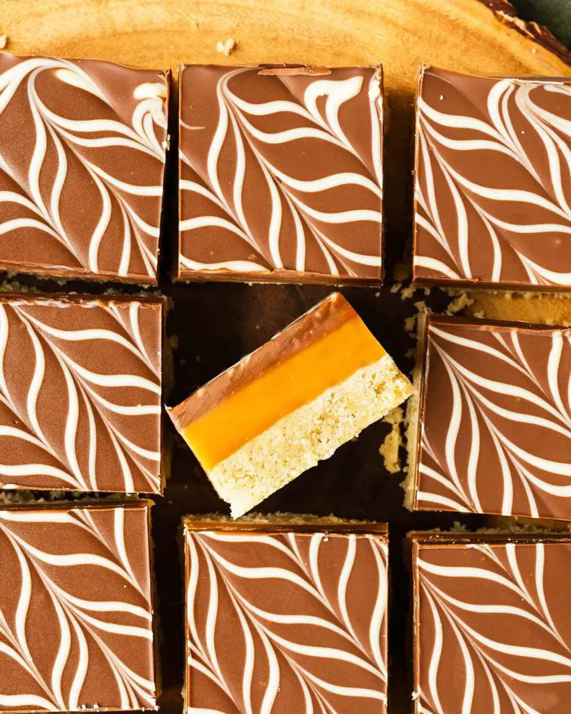 A rich, layered dessert, millionaire’s shortbread (or caramel slice) has a buttery shortbread base, a rich caramel layer, and a smooth feathered milk and white chocolate topping. A favourite, classic British bake, and with good reason too! Recipe by movers and bakers