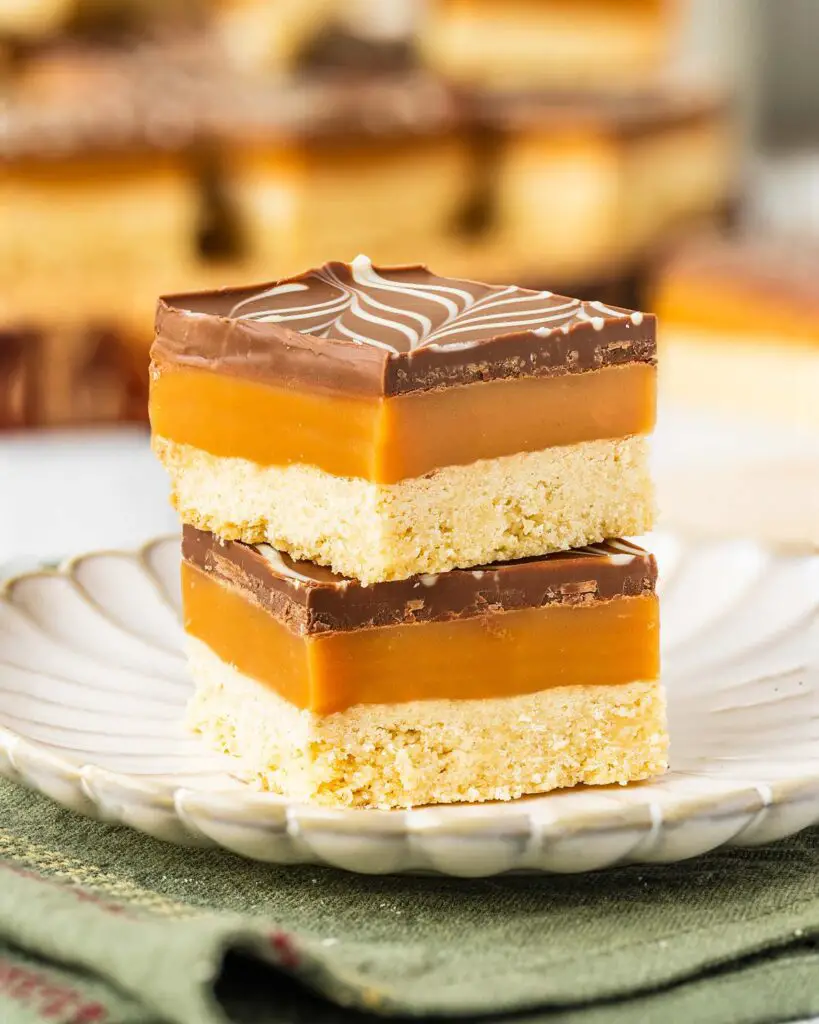 A rich, layered dessert, millionaire’s shortbread (or caramel slice) has a buttery shortbread base, a rich caramel layer, and a smooth feathered milk and white chocolate topping. A favourite, classic British bake, and with good reason too! Recipe by movers and bakers