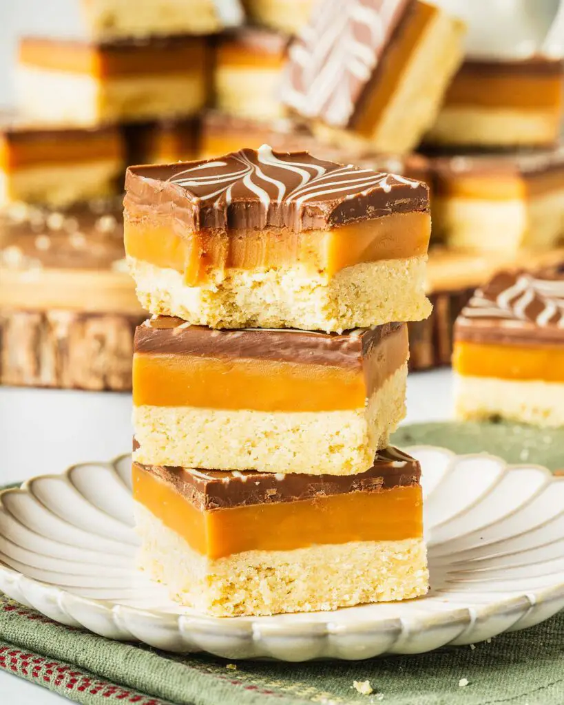 A rich, layered dessert, millionaire’s shortbread (or caramel slice) has a buttery shortbread base, a rich caramel layer, and a smooth feathered milk and white chocolate topping. A favourite, classic British bake, and with good reason too! Recipe by movers and bakers
