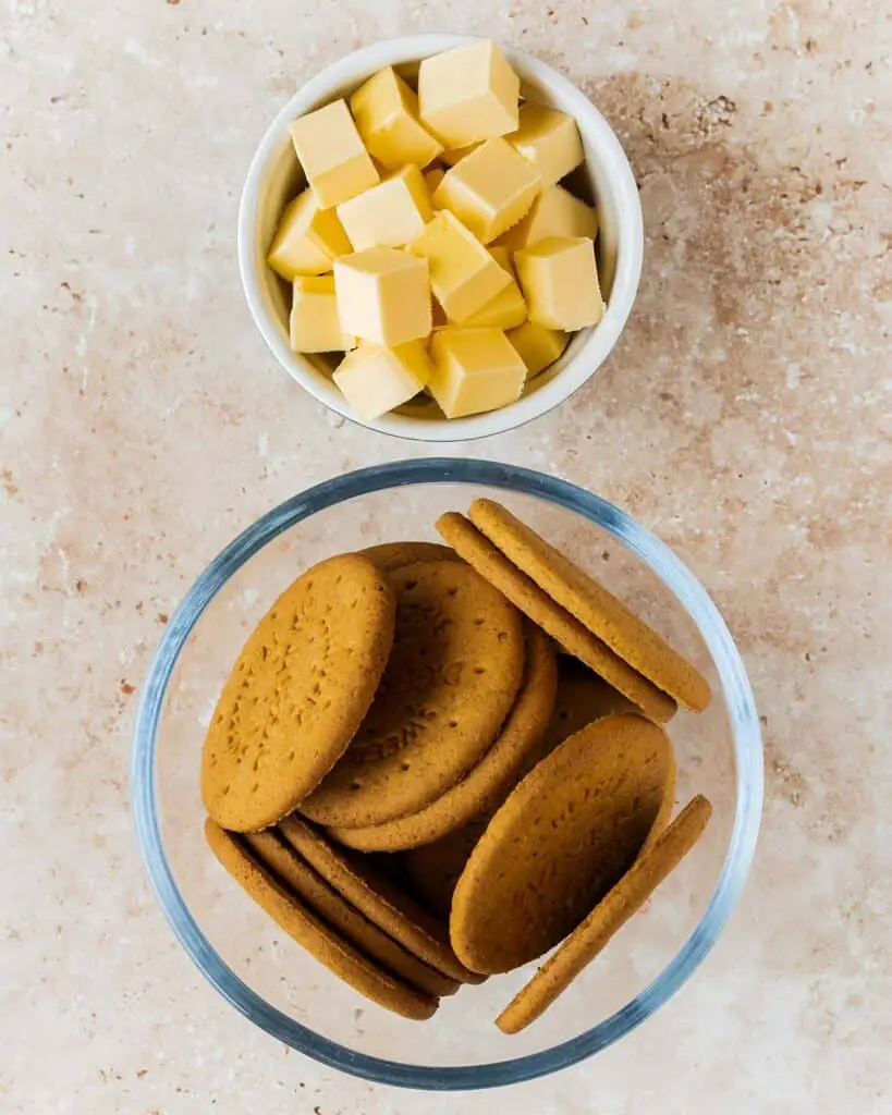 Ingredients required for the base: digestive biscuits and unsalted butter. Recipe by movers and bakers