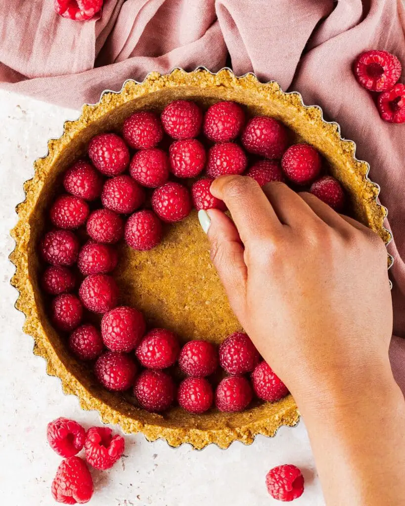 Arranging the raspberries in the bottom of the chilled base...