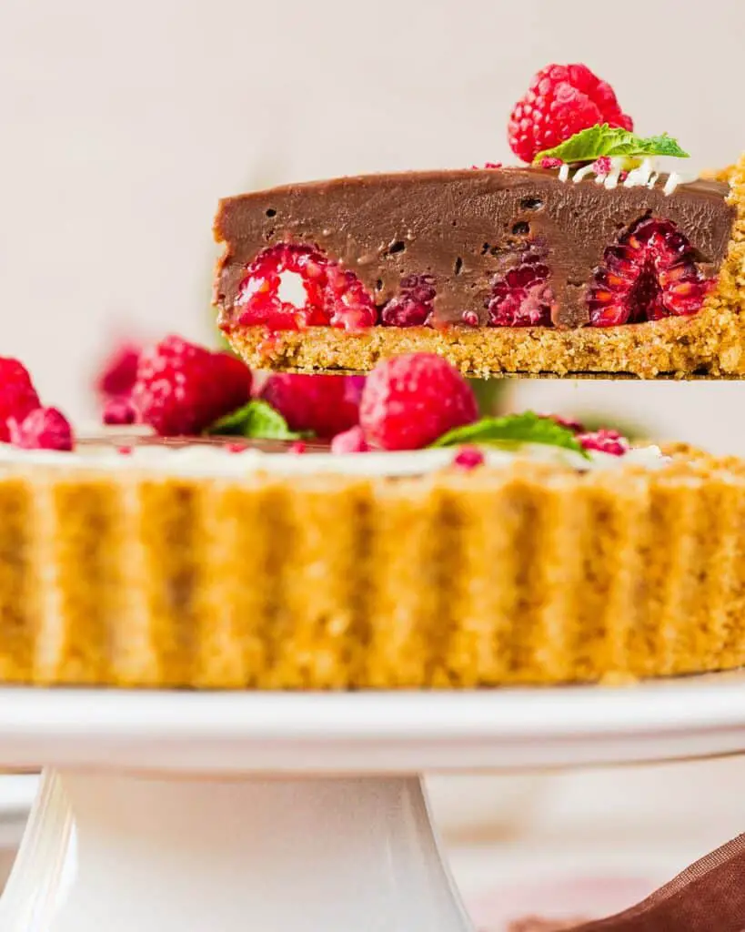 My chocolate raspberry tart is the perfect dessert for sophisticated and elegant entertaining, but with minimal and easy prep! Buttery biscuit base, fresh tart raspberries and a smooth and creamy milk chocolate filling make this a dreamy dessert everyone will love. Recipe by movers and bakers