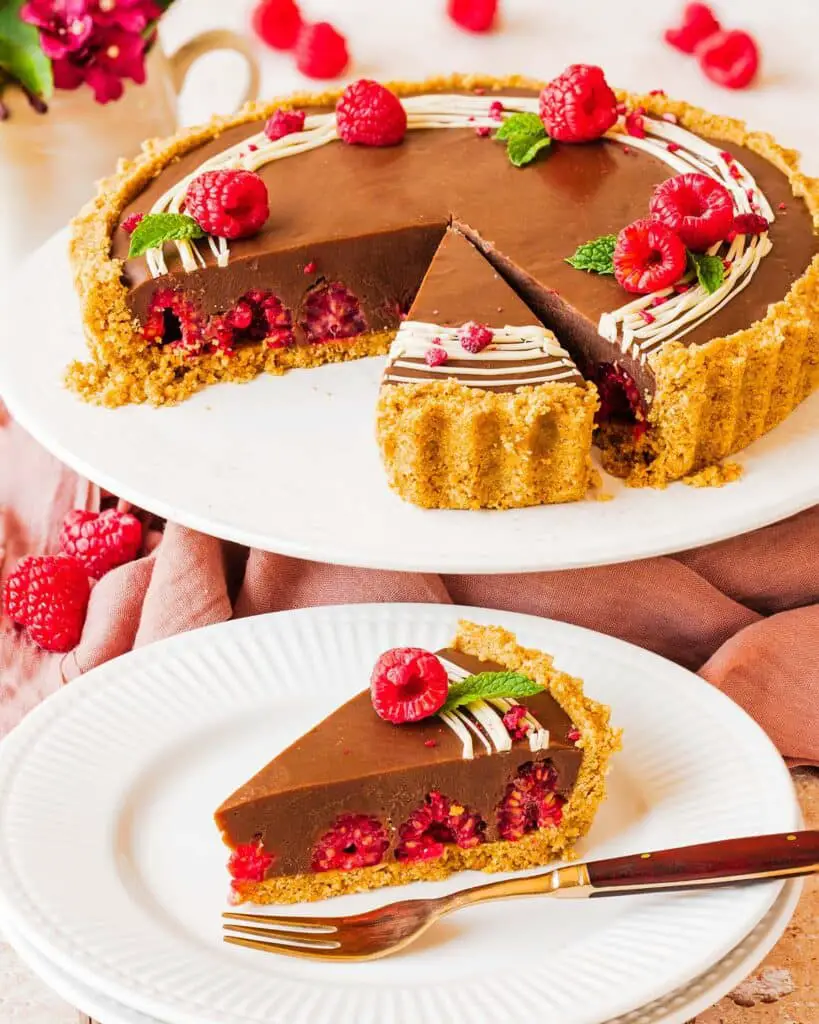 My chocolate raspberry tart is the perfect dessert for sophisticated and elegant entertaining, but with minimal and easy prep! Buttery biscuit base, fresh tart raspberries and a smooth and creamy milk chocolate filling make this a dreamy dessert everyone will love. Recipe by movers and bakers