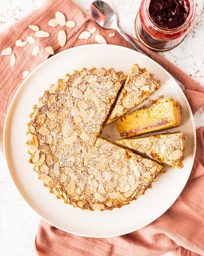 Biscuity shortcrust, rich raspberry jam and moreish frangipane all topped with flaked almonds, a traditional Bakewell Tart is utterly delish! Recipe by movers and bakers