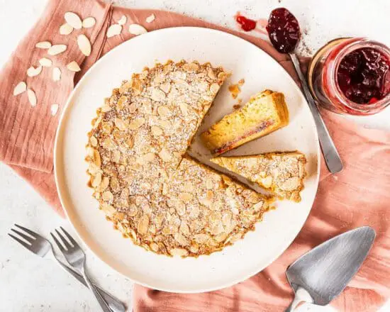 Biscuity shortcrust, rich raspberry jam and moreish frangipane all topped with flaked almonds, a traditional Bakewell Tart is utterly delish! Recipe by movers and bakers