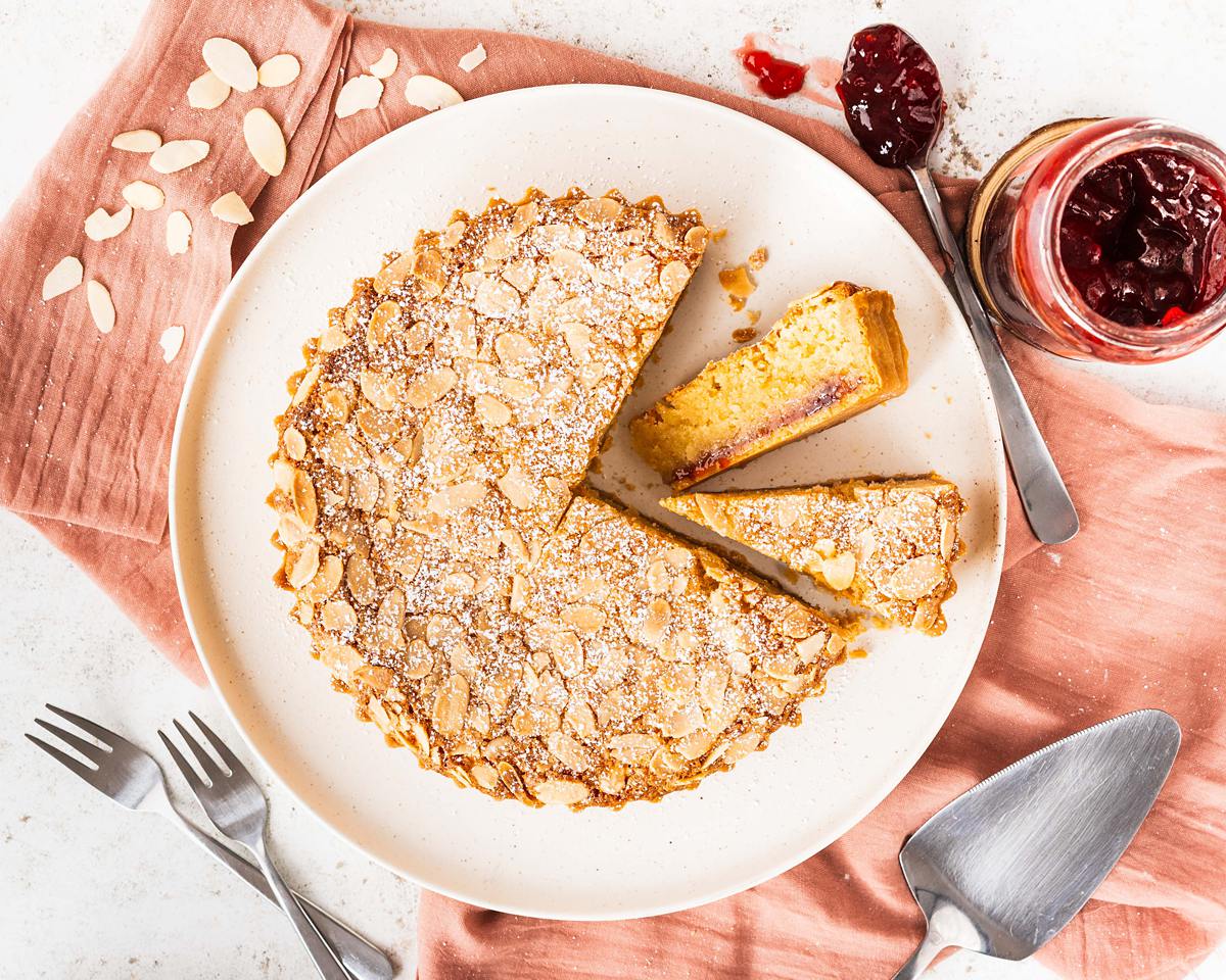 Biscuity shortcrust, rich raspberry jam and moreish frangipane all topped with flaked almonds, a traditional Bakewell Tart is utterly delish! Recipe by movers and bakers