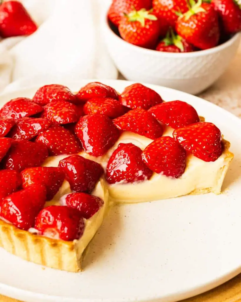 My strawberry tart recipe is hugely inspired by the glorious French strawberry tart we enjoy during out holidays! Buttery shortcrust pastry, smooth creme patisserie and beautifully glazed fresh strawberries make this a summertime treat! Recipe by movers and bakers