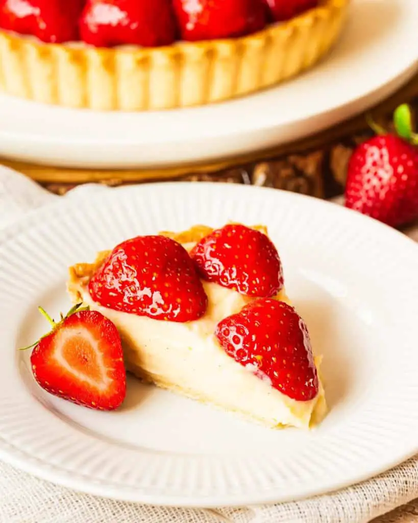 My strawberry tart recipe is hugely inspired by the glorious French strawberry tart we enjoy during out holidays! Buttery shortcrust pastry, smooth creme patisserie and beautifully glazed fresh strawberries make this a summertime treat! Recipe by movers and bakers