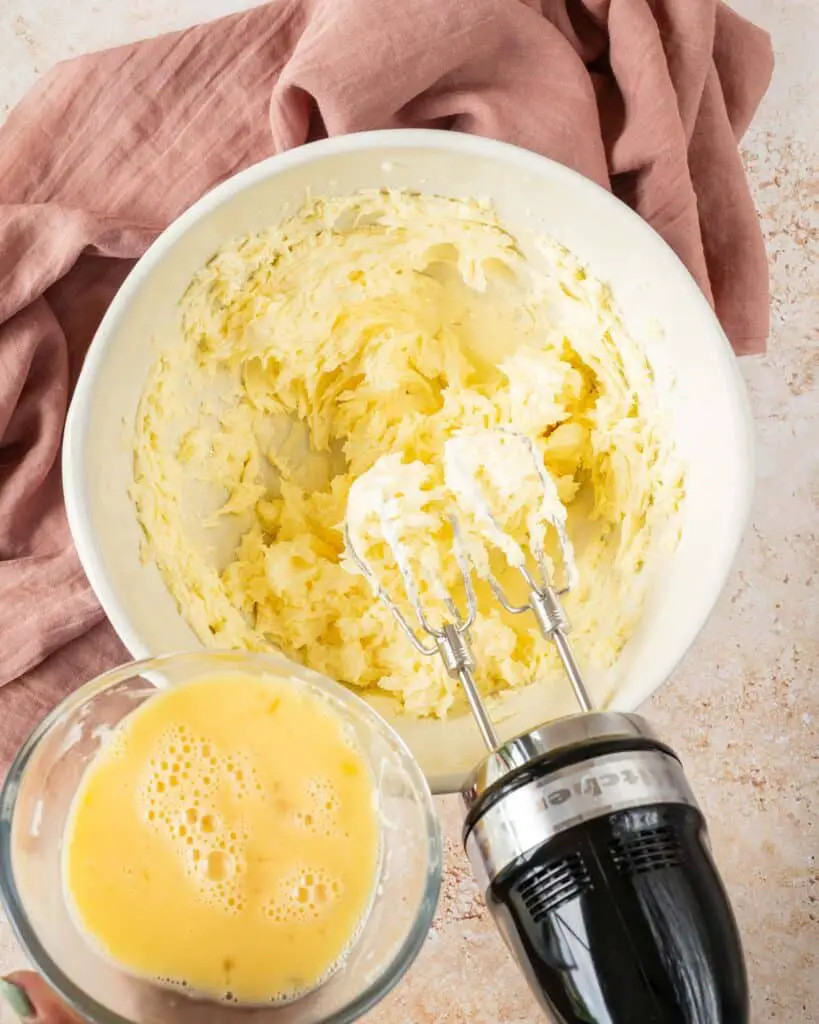 Gradually adding the eggs to the beaten butter and sugar. Recipe by movers and bakers