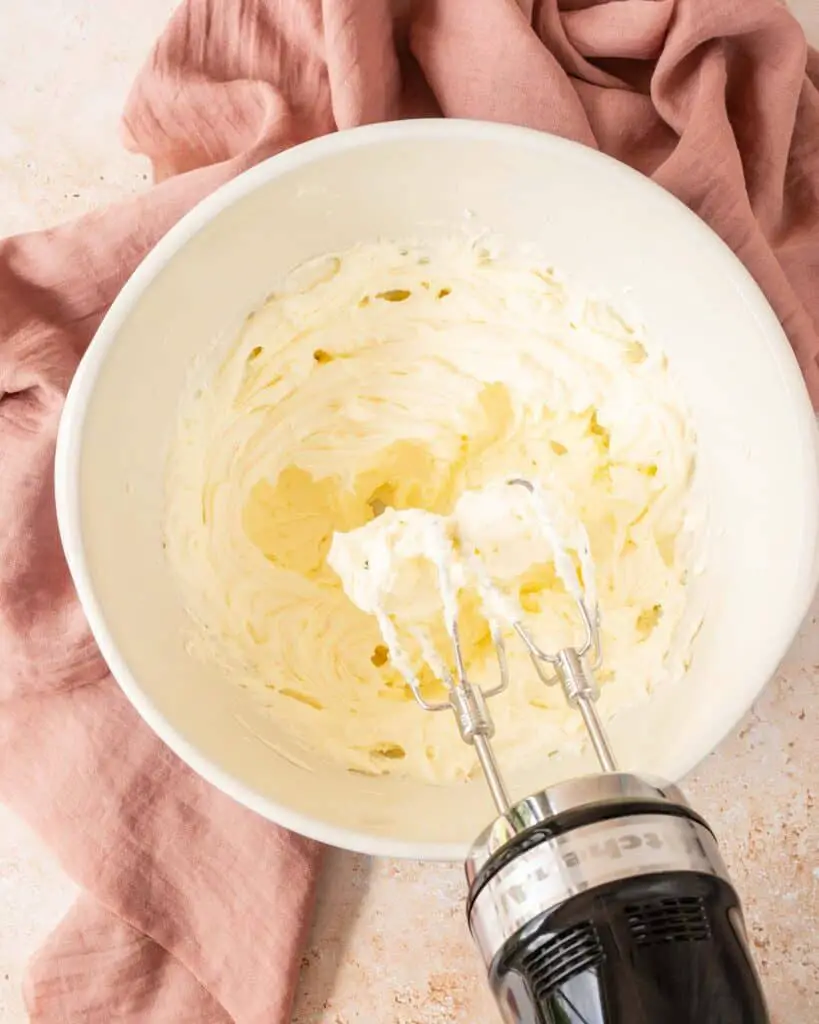 The finished buttercream will be pale, soft and creamy. Recipe by movers and bakers