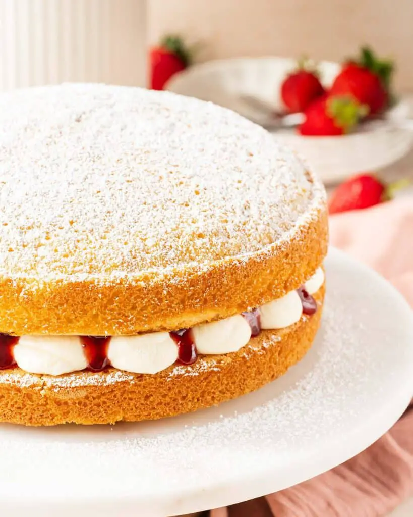 A simple British classic, the Victoria sandwich has two layers of light and fluffy vanilla sponge cake filled with soft vanilla buttercream and tart raspberry jam. Finish with a dusting of icing (powdered) sugar for the ultimate tea time treat! Recipe by movers and bakers