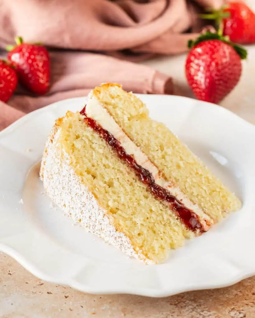 A simple British classic, the Victoria sandwich has two layers of light and fluffy vanilla sponge cake filled with soft vanilla buttercream and tart raspberry jam. Finish with a dusting of icing (powdered) sugar for the ultimate tea time treat! Recipe by movers and bakers
