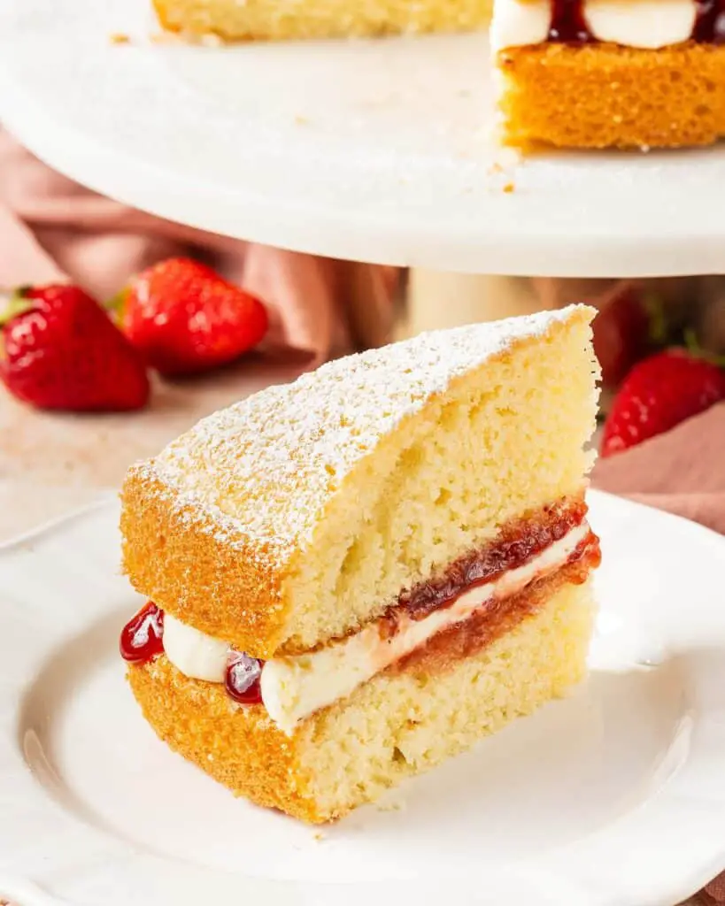 A simple British classic, the Victoria sandwich has two layers of light and fluffy vanilla sponge cake filled with soft vanilla buttercream and tart raspberry jam. Finish with a dusting of icing (powdered) sugar for the ultimate tea time treat! Recipe by movers and bakers