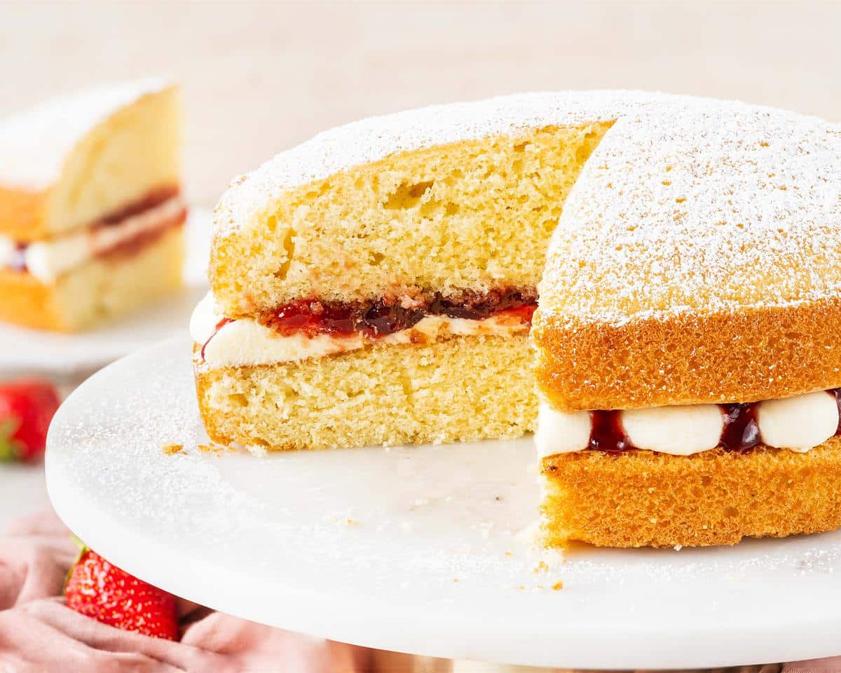A simple British classic, the Victoria sandwich has two layers of light and fluffy vanilla sponge cake filled with soft vanilla buttercream and tart raspberry jam. Finish with a dusting of icing (powdered) sugar for the ultimate tea time treat! Recipe by movers and bakers