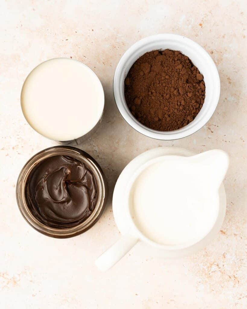 Ingredient required: double (heavy) cream, sweetened condensed milk, cocoa powder and chocolate fudge sauce. Recipe by movers and bakers