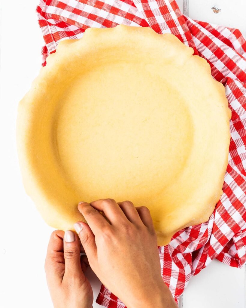 Before placing in the pie dish and easing into the corners. Recipe by movers and bakers