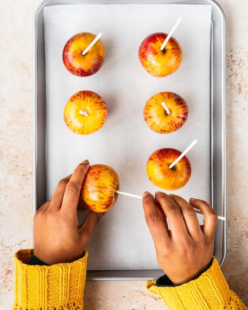 Preparing the apples for dipping in the syrup. Recipe by movers and bakers