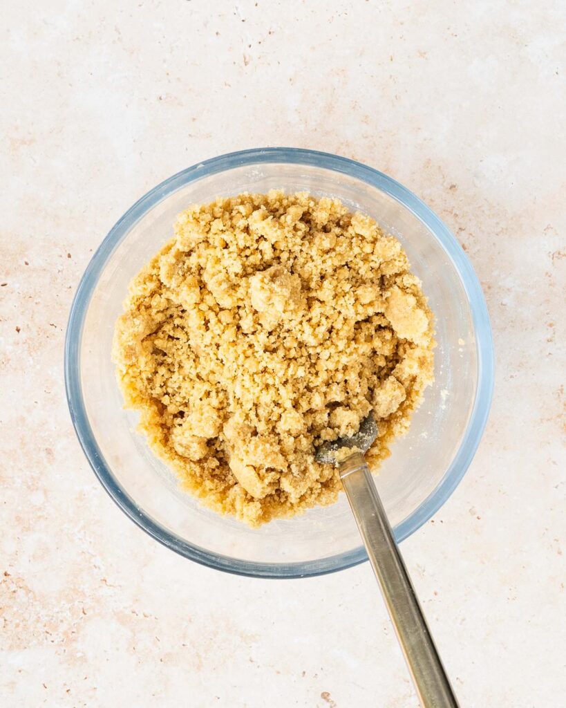 Mix together the crumble ingredients until they are combined and clumping. Recipe by movers and bakers