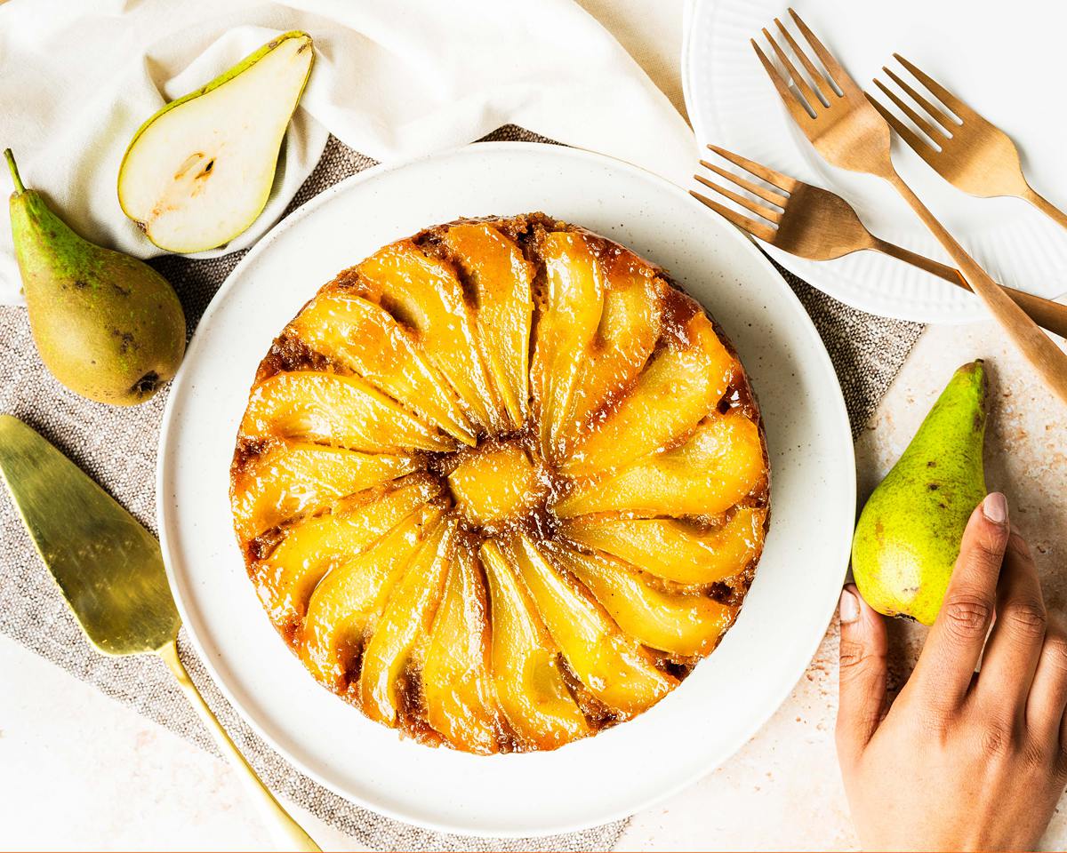 My pear upside down cake makes the most of gorgeous seasonal pears, stunning golden caramel and a lightly spiced cake (with a crumble crunch!) for the ultimate start to autumnal bakes! Recipe by movers and bakers