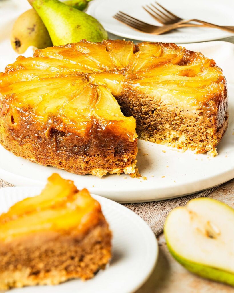 My pear upside down cake makes the most of gorgeous seasonal pears, stunning golden caramel and a lightly spiced cake (with a crumble crunch!) for the ultimate start to autumnal bakes! Recipe by movers and bakers
