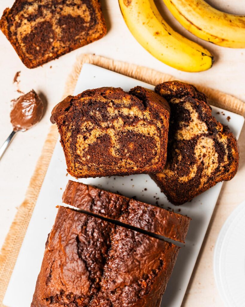 Elevate the classic banana bread with Nutella delectable twist on a classic! Nutella banana bread is the perfect homely bake for any time! Recipe by movers and bakers