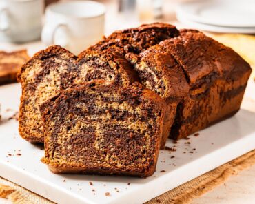 Elevate the classic banana bread with Nutella delectable twist on a classic! Nutella banana bread is the perfect homely bake for any time! Recipe by movers and bakers