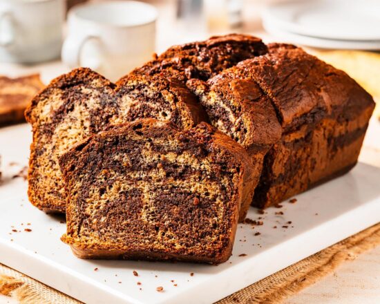 Elevate the classic banana bread with Nutella delectable twist on a classic! Nutella banana bread is the perfect homely bake for any time! Recipe by movers and bakers