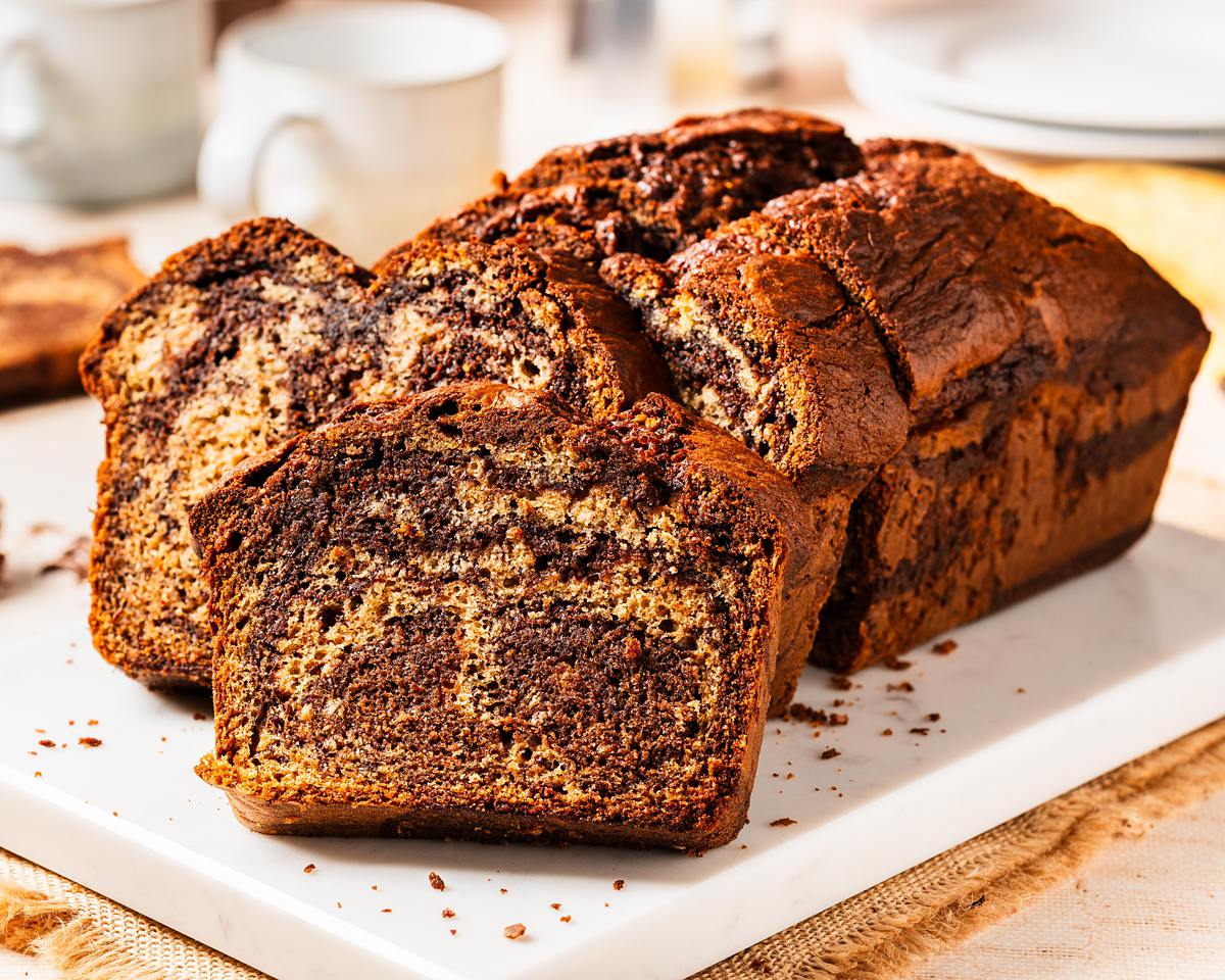 Elevate the classic banana bread with Nutella delectable twist on a classic! Nutella banana bread is the perfect homely bake for any time! Recipe by movers and bakers