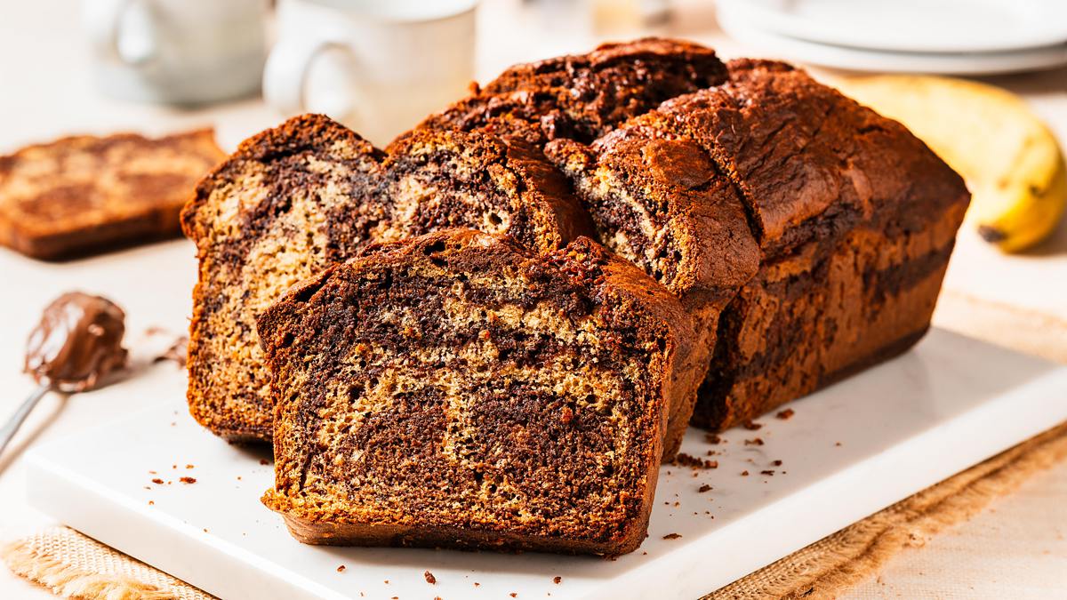 Elevate the classic banana bread with Nutella delectable twist on a classic! Nutella banana bread is the perfect homely bake for any time! Recipe by movers and bakers