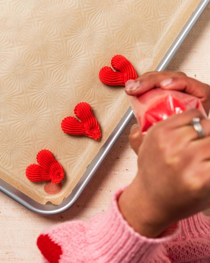 To create little piped biscuit hearts before freezing to firm up ahead of baking. Recipe by movers and bakers