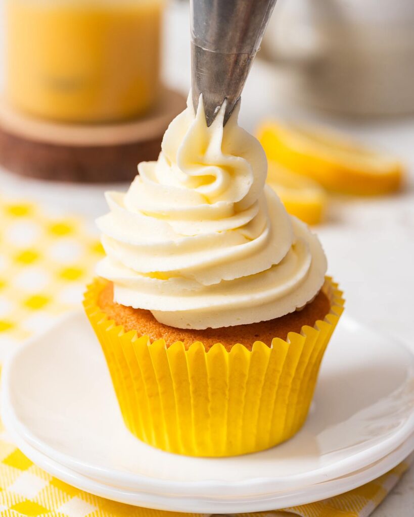 Before topping with a swirl of lemon buttercream and a drizzle of lemon curd. Recipe by movers and bakers