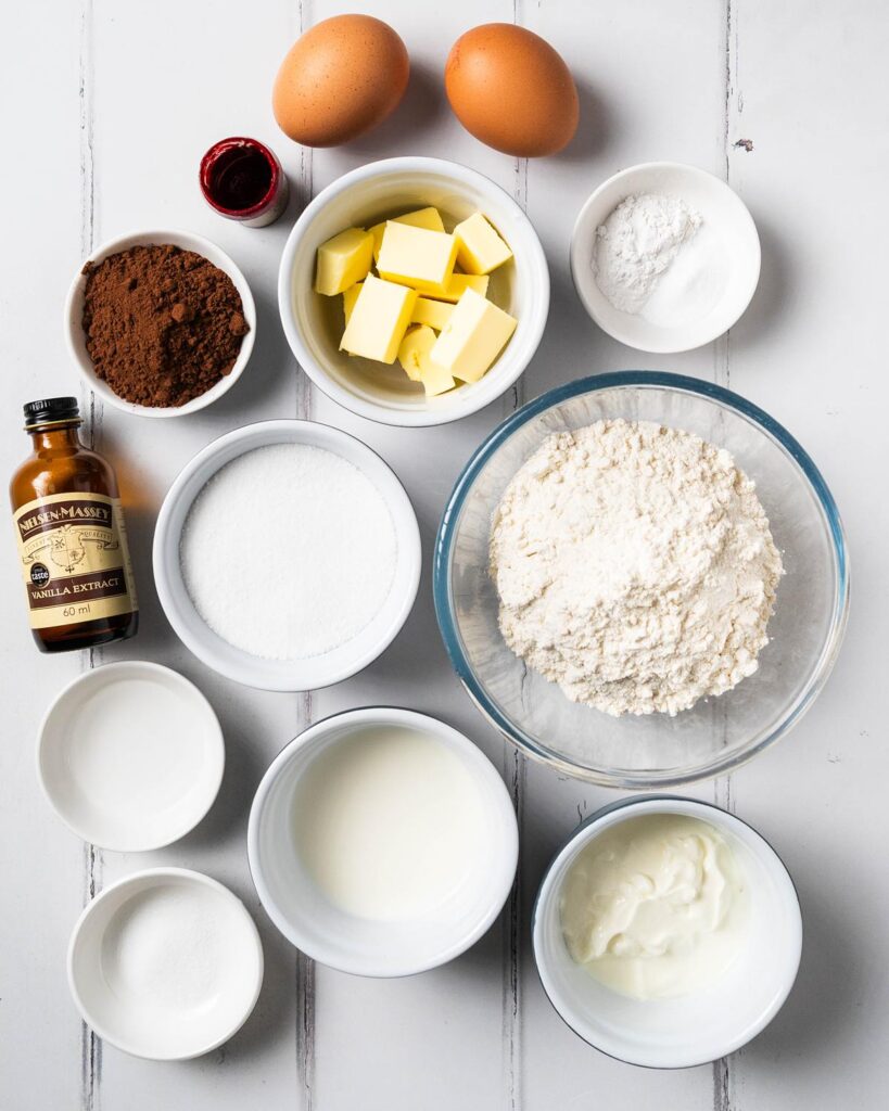 Ingredients for the cupcakes: unsalted butter, vanilla, food colouring, eggs, milk, yogurt, plain (all purpose) flour, baking powder, cocoa powder, bicarbonate of soda (baking soda) and vinegar. Recipe by movers and bakers