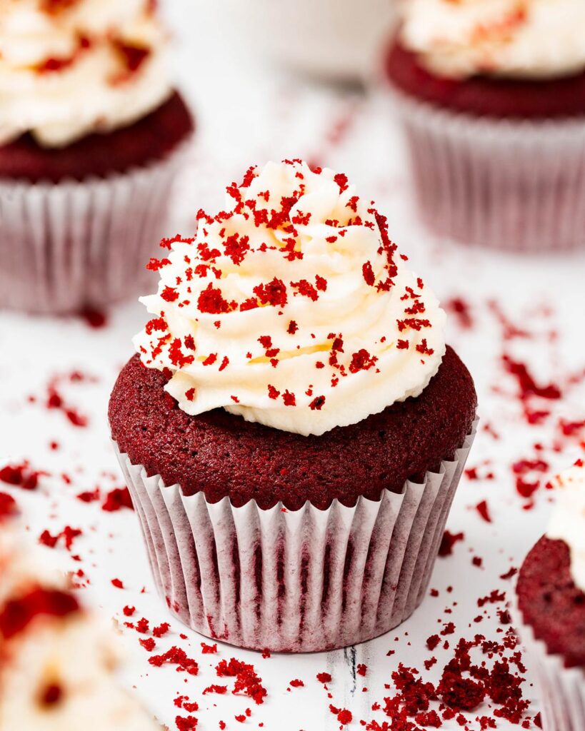 Vanilla and cocoa light velvety cupcakes topped with a glorious swirl of cream cheese frosting, these red velvet cupcakes are absolutely irresistibly divine! Recipe by movers and bakers