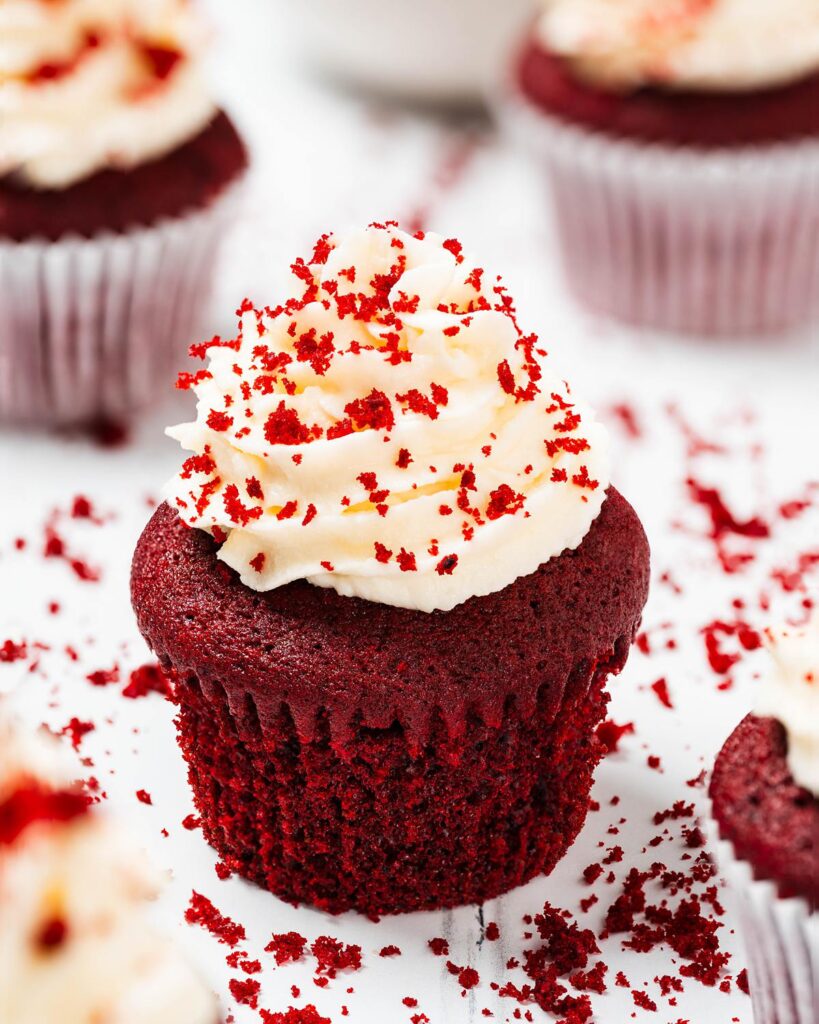 Vanilla and cocoa light velvety cupcakes topped with a glorious swirl of cream cheese frosting, these red velvet cupcakes are absolutely irresistibly divine! Recipe by movers and bakers