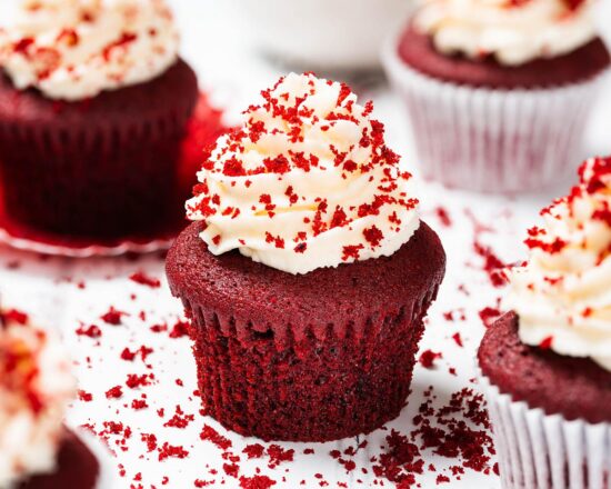 Vanilla and cocoa light velvety cupcakes topped with a glorious swirl of cream cheese frosting, these red velvet cupcakes are absolutely irresistibly divine! Recipe by movers and bakers