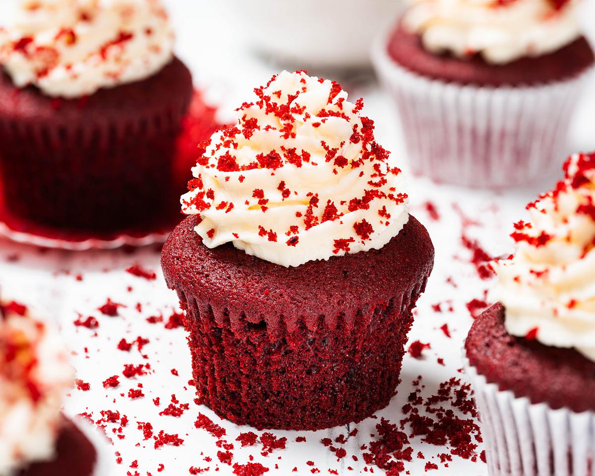 Vanilla and cocoa light velvety cupcakes topped with a glorious swirl of cream cheese frosting, these red velvet cupcakes are absolutely irresistibly divine! Recipe by movers and bakers