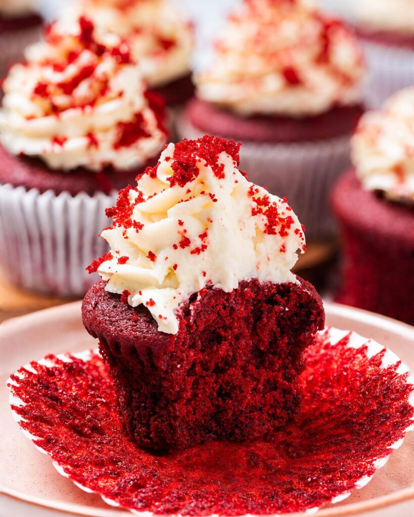 Vanilla and cocoa light velvety cupcakes topped with a glorious swirl of cream cheese frosting, these red velvet cupcakes are absolutely irresistibly divine! Recipe by movers and bakers