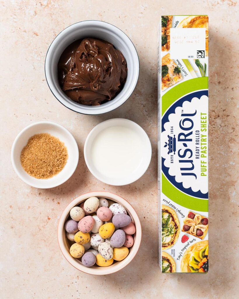 Ingredients required: ready-rolled puff pastry, Nutella, milk, demerara sugar (optional) and mini eggs. Recipe by movers and bakers