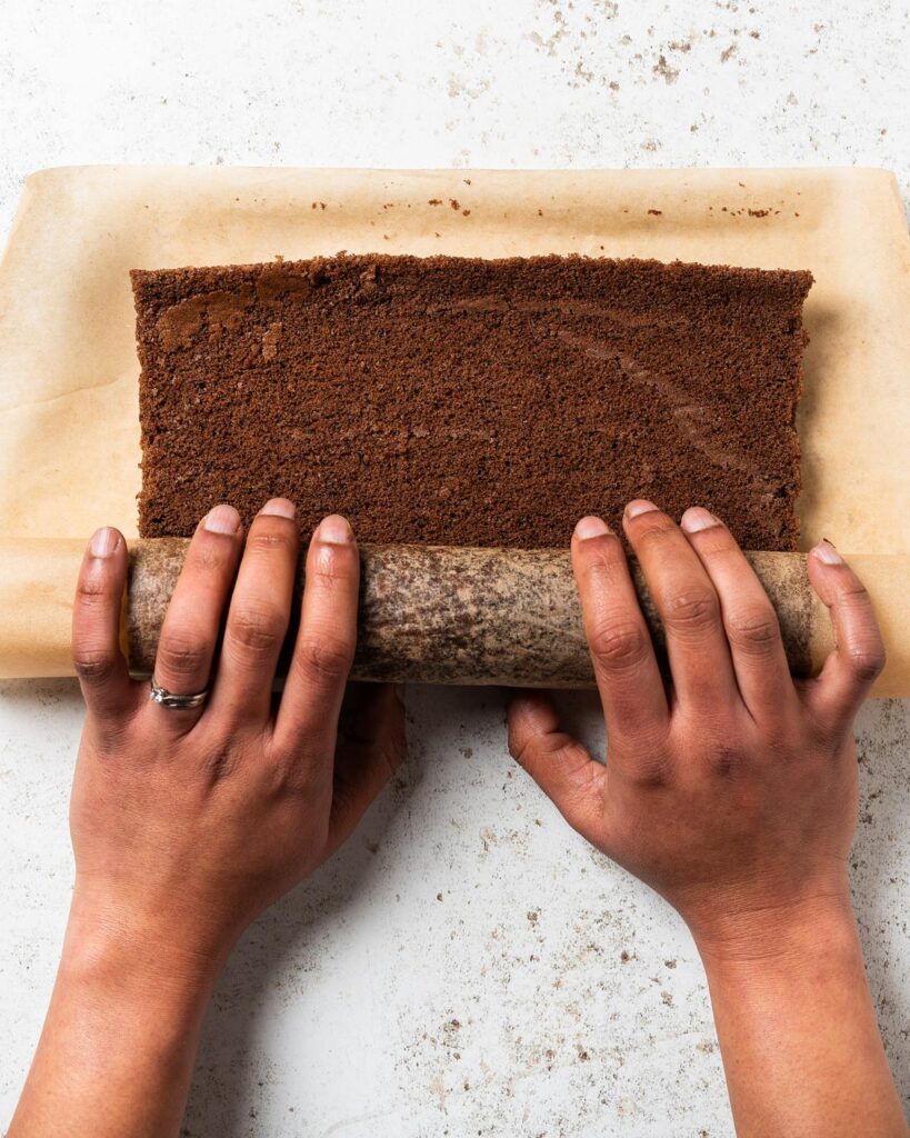 Rolling up the cake after baking before leaving to cool. Recipe by movers and bakers