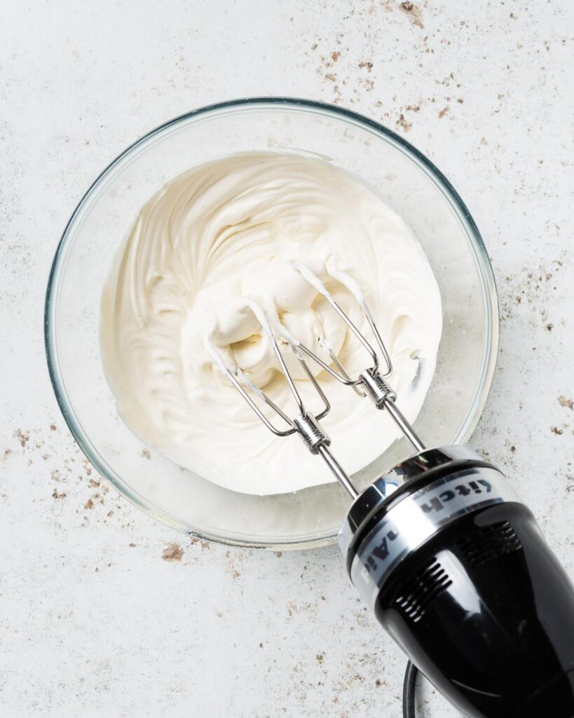 Whisking up the Chantilly cream before using to fill in the cake. Recipe by movers and bakers