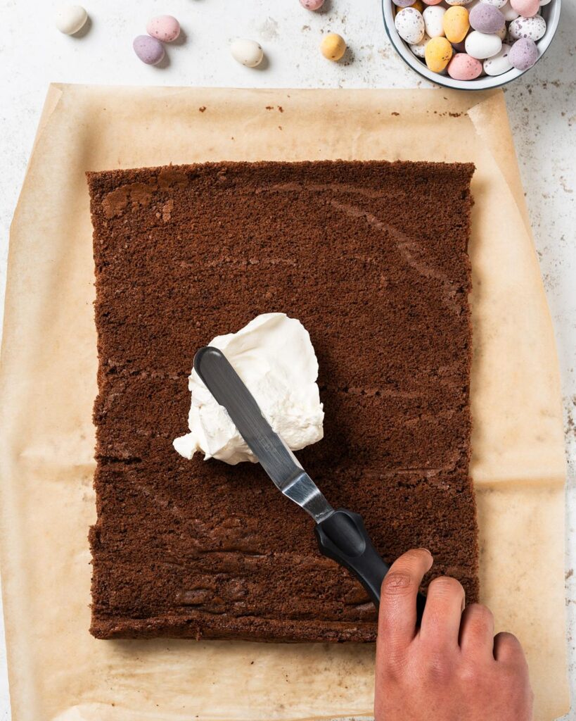 Spreading over the Chantilly cream onto the unrolled cake...