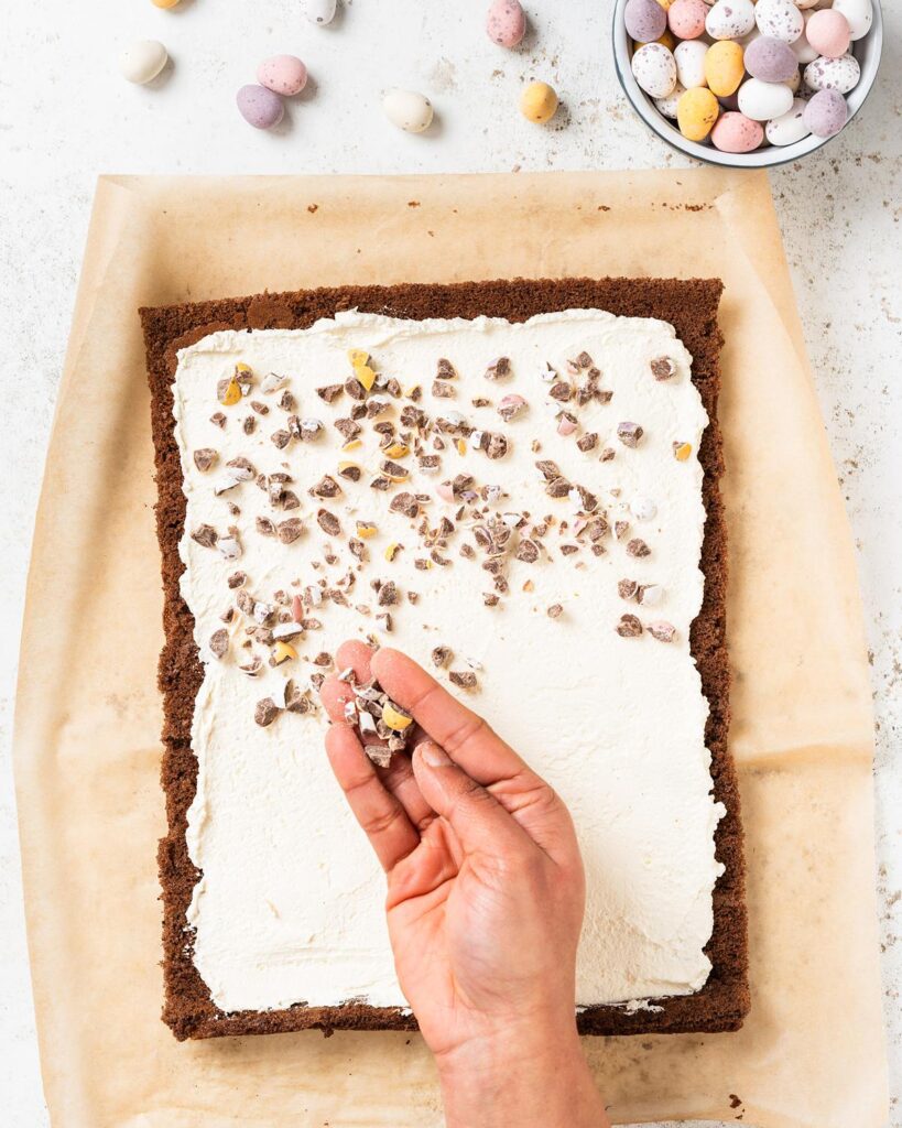 Then top with crushed mini eggs before rolling the mini egg swiss roll back up again. Recipe by movers and bakers