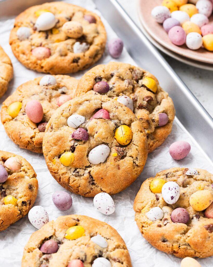 Make the BEST EVER Cadbury's mini egg cookies. They are chunky and chewy, with plenty of dark chocolate chips and mini eggs to keep even the most die hard fan happy! So easy to make, perfect for using up all those extra mini eggs! Recipe by movers and bakers