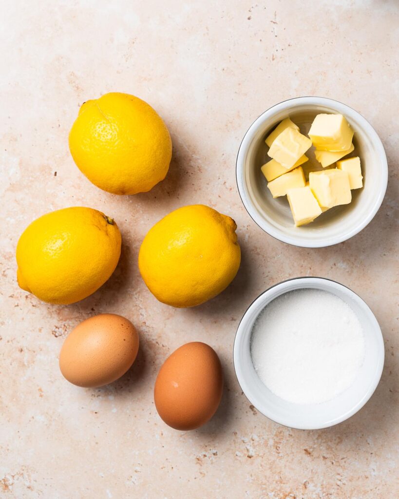Ingredients to make the homemade curd: lemons, eggs, butter and sugar. Recipe by movers and bakers