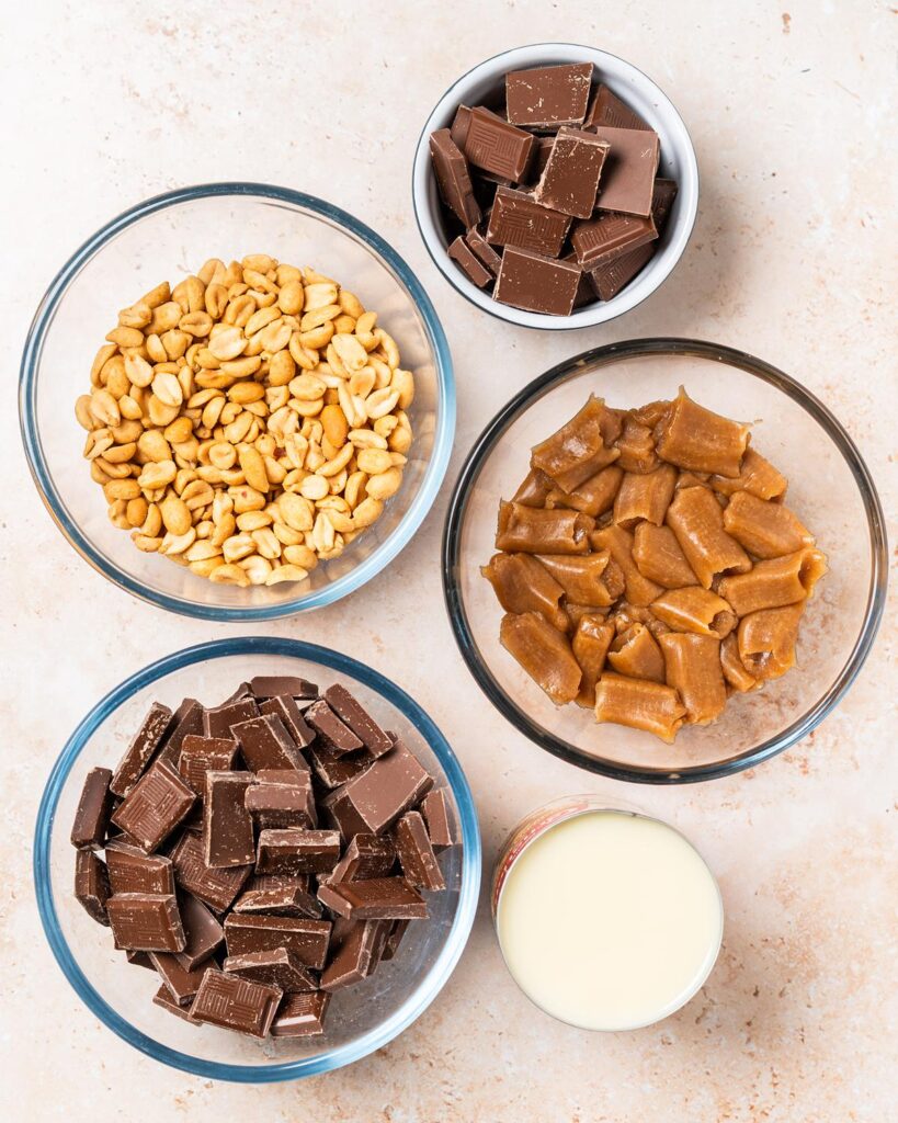 Ingredients required: chocolate, sweetened condensed milk, salted peanuts and caramel sweets. Recipe by movers and bakers