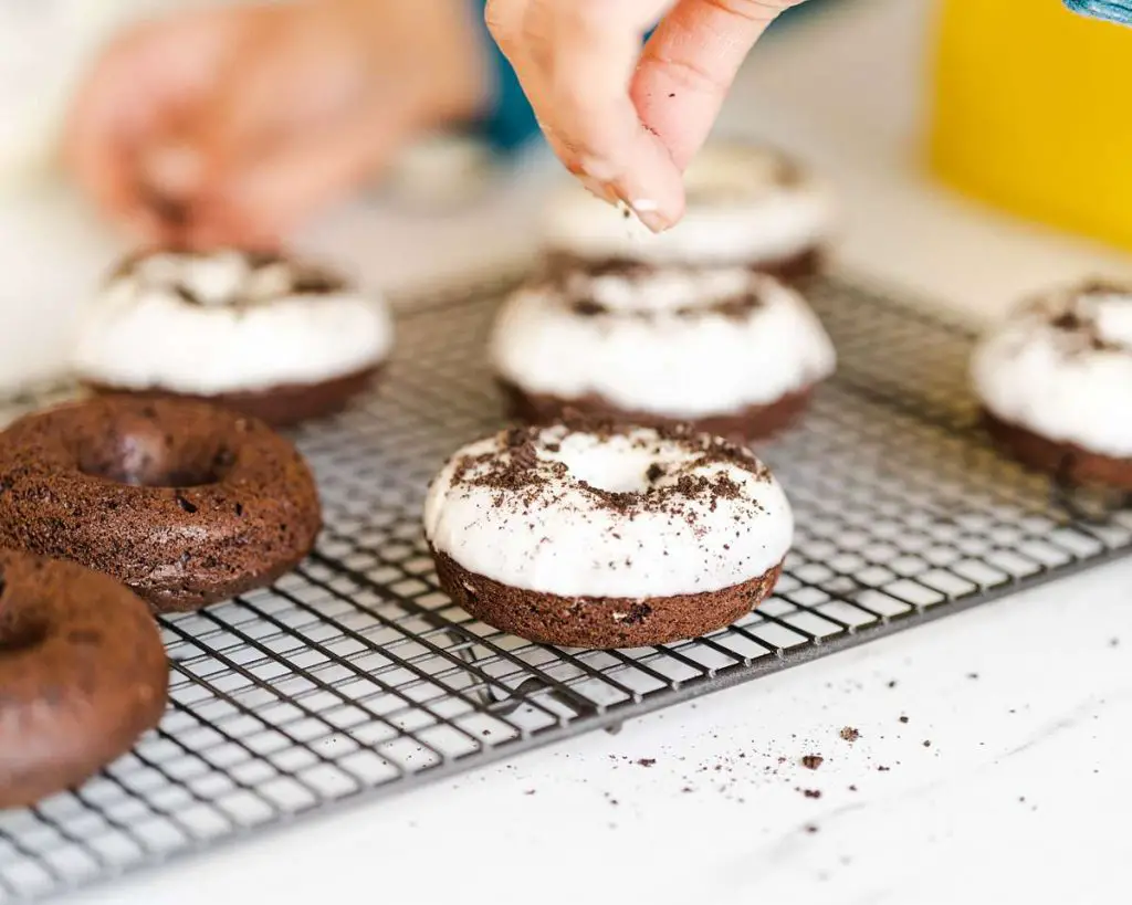 Adding the finishing touches to the donuts. Recipe by movers and bakers