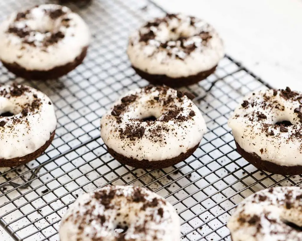 Delicious cakey, chocolatey Oreo donuts are light and delicious, topped with a yummy tangy cream cheese glaze. Recipe by movers and bakers